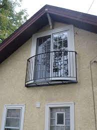 A custom wrought iron french country style juliet balcony painted copper patina over black with scroll elements for a residential property in wilmette. Juliette Balconies Juliette Balcony Juliet Balcony French Balcony