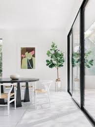 A large dining room featuring hardwood flooring and beige walls. Best 41 Modern Dining Room Porcelain Tile Floors Design Photos And Dwell