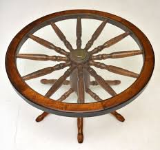 It looks much larger online than in person. Vintage Wagon Wheel Coffee Table With Glass Top For Sale At Pamono