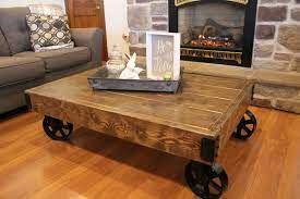 This smart storage coffee table niftily blends stacking space and lift top functions along with appealing aesthetics. Coffee Table With Iron Caster Wheels Rustic Cart Vintage Design Wood Rustic Table Ideas Of Rustic Table Coffee Table Rustic Table Extendable Coffee Table
