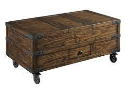 The spot where storage space meets style, this coffee table trunk lets you tuck away blankets and board games without disrupting your den aesthetic. Hammary Hidden Treasures Industrial Trunk Coffee Table With Storage Find Your Furniture Cocktail Coffee Tables
