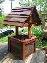 This awesome wishing well can be built in a couple of weekends. A Wishing Well Made Of Pallets Diy Wishing Wells Well House Wishing Well