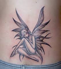 Black and pink fairy on half moon tattoo design for lower back. 20 Mind Blowing Fairy Tattoos Pictures Sheideas