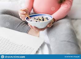Close Up Of Pregnant Woman Eating Muesli With Blueberries While Working On Laptop Stock Photo Image Of Blue Dieting 187101756