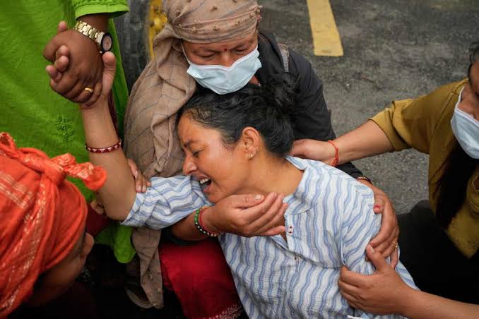 Nepal's Chitwan buries flood victims in unmarked graves as mother touches son's shroud in final farewell; deaths mount as 12 more bodies found in Narayani River