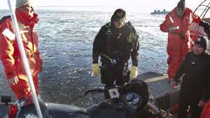 Snowmobile rider glides over mile of open water