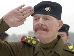 Iraqi Female Officer in Front of Saddam Hussein Portrait, 1991 :  r/RareHistoricalPhotos