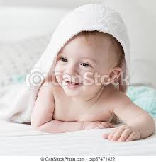 Keep a small, dry towel nearby to wipe his face if he gets upset when it does get wet or if soap gets in his eyes. Closeup Portrait Of Smiling Baby Boy Lying On Bed With Towel On Head After Having Shower Portrait Of Smiling Baby Boy Lying Canstock