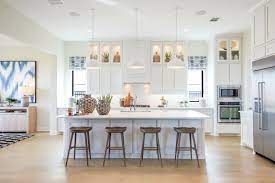Light Airy And Inviting White Cabinetry And Light Central Island Foster A Charming Kitchen Ambiance Loc House Design Kitchen Home Kitchens Kitchen Remodel