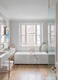 Diy tub skirt (decorative panel) for a standard soaking tub. See Stylish Bathroom Ideas That Have Brass As The Main Decor Detail