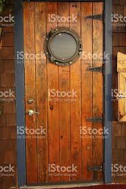 the door to a restaurant featuring a port hole wood doors interior wood french doors french doors interior
