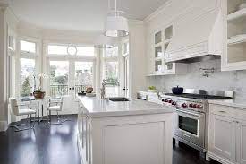 Cool white kitchen, with a stunning statuary white marble island. Cream Kitchen Cabinets With White Marble Countertops Transitional Kitchen