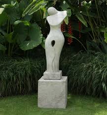 The transitional home features broad sliding doors that open the home's interior to its exterior living spaces. Timeless Garden Sculpture Modern Stone Statue