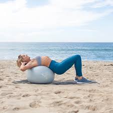 Lie on your back and balance your legs on a yoga ball to form a bridge pose. 8 Yoga Ball Workouts For A Toned Core