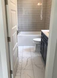 The Tile Flooring That Looks Like Marble In This Bathroom Creates A Stunning Look It Is Light And Gives Bathroomremodel In 2020 Marble Bathroom Floor Bathrooms Remodel Small Bathroom Remodel