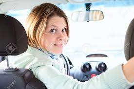Image of a young woman having a back pain while sitting at the working desk. Joyful Woman Inside Of Car Looking Back From Driver Seat Stock Photo Picture And Royalty Free Image Image 15771617
