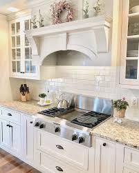 After cutting both materials to fit between your countertop and cabinets, soak the fabric in a mixture of one part decoupage glue to two parts water, and then gently wring it out. Off White Kitchen Cabinets Giallo Ornamental Granite Glass Cabinet Doors Sherwin Kitchen Cabinets Decor Antique White Kitchen Antique White Kitchen Cabinets