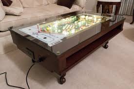 I know that others have put playfields into coffee tables, and some have gone so far as to light them up, but this project goes beyond that! Pinball Coffee Table Skunkwerx