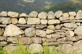 Rounded rocks are almost impossible to build into a wall without using copious amounts of mortar. How To Build A Dry Freestanding Stone Wall The Right Way