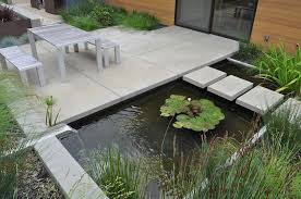 Cement Tiles Small Pond Bushes Grass Garden Metal Furniture Backyard Ideas For Small Backyards In 2020 Modern Garden Design Modern Garden Pond Design