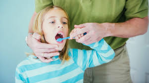 Family brushing teeth together in bathroom. How To Brush Your Child S Teeth Ages 5 8 Kids Teeth