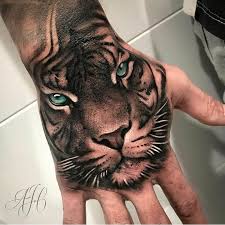 15 Cool Hand Tattoos Tiger Tattoo Designs Petpress Hand Tattoos Hand Tattoos For Guys Lion Hand Tattoo