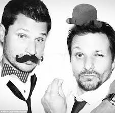 Nick Lachey kisses pregnant wife Vanessa's bump in touching family  Christmas card