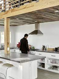 A ceiling fan cools an outdoor kitchen featuring white woven leather counter stools placed at an island clad in bedrosians enchante porcelain tiles and finished with a poured concrete countertop. Dwell S Favorite 37 Modern Kitchen Concrete Counters Design Photos Dwell