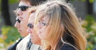 Widow lashes out at cop's killer