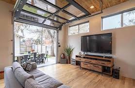 These doors can be used as a standard exterior garage door, an interior partition, or even as a versatile patio door that can seamlessly merge indoor and outdoor spaces. Garage Door In Living Room Design Types Ideas Designing Idea