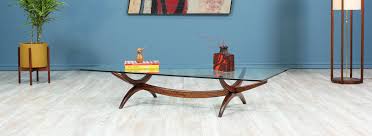 Gorgeous midcentury oval shaped coffee table with slightly slanted solid wood tapered legs, a walnut veneer top, and a breathtaking dark pecan finish. Mid Century Modern Sculpted Rosewood Glass Coffee Table Danish Modern L A