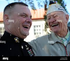 World War II veteran Edwin Fitchett holds the Cine Kodak Model K 16mm film  camera he used to shoot scenes in Japan and the Philippines following the  war, in his home in