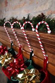 They provide quite a sweet home base for your family's christmas stockings. Candy Cane Stocking Holder Hooks Christmas Store Christmas Candy Cane Decorations Christmas Mantel Decorations Christmas Store