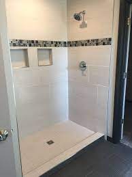 Custom Tiled Shower With 12x24 Satiated Tile Run 1 3 Staggered Vertically With A Glass And Metal Mosaic Acce Basement Remodeling Shower Tile Custom Tile Shower