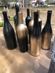Black And Gold Painting Diy Black Gold Wine Bottle Centerpieces Wine Bottle Centerpieces Bottle Centerpieces Wedding Wine Bottles