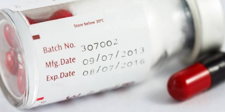 Close-up of a medicine bottle showing its printed expiration date