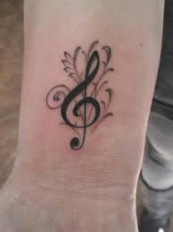 The bright bow on the middle finger is a wonderful emotional addition to your image. 50 Cool Music Tattoo Designs And Ideas