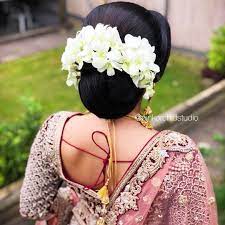 What A Beautiful Large Low Bun With Real Flower Gajra Care However Should Be Taken Before Adopting Such Hai Brunette Hair Color Pink Orchid Studio Bridal Updo