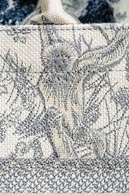 Designed to hold all daily essentials, the style has been fully embroidered with blue check'n'dior motif and embellished and embellished with the 'christian dior' signature on the front. Stunning Dior Toile De Jouy Embroidery Book Tote Purseblog