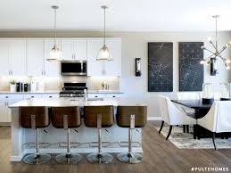 A Sleek Kitchen With All The Modern Comforts Of Home Decorative Lighting Illuminates The Space Modern Kitchen Design Sleek Kitchen Contemporary Kitchen Design