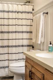 Swap out your bland white shower curtain for one of these unique numbers your bedroom is your temple, and your living room is designed for showing off — but your bathroom? New Towels A New White And Black Tribal Inspired Shower Curtain And A Few Other Simple Bathroom Decor Id Simple Bathroom Simple Bathroom Decor Bathroom Decor