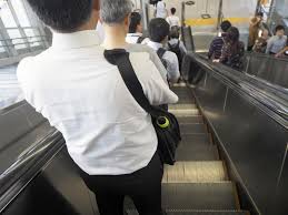 An escalator is a moving staircase with steps that carry people up or down using a conveyor belt and tracks, keeping each step horizontal for the passengers. Stand And Be Delivered Japan S Evolving Escalator Etiquette The Japan Times