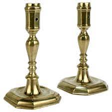 With three candlesticks in the shape of palm trees and an elephant family passing by, this vintage brass candle holder will brighten. Pair Of Early 18th Century French Or English Faceted Brass Candlesticks For Sale At 1stdibs