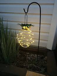 This Hanging Solar Lantern Features The Classic Pineapple Welcome Symbol Hang This Cheerful Yell Outdoor Fairy Lights Solar Hanging Lanterns Pineapple Lights