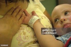 CHILDRENS28-- Carter Harris holds his mother's hand, Danette Tafoia,...  News Photo