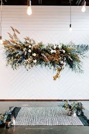 A few floral installations hanging the length of the aisle will tie in with any flower arrangements below. Hanging Flower Installations Elevate An Alternative Wedding Hey Wedding Lady