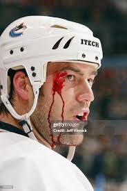 Blood oozes from the face of Todd Bertuzzi of the Vancouver Canucks... News  Photo