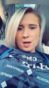 Blonde Individual in Car Wearing Graphic T-Shirt