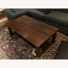 Crafted with a locally sourced hardwood frame and engineered wood, this chic piece is pretty to sit on and built to last. Crate Barrel Solid Wood Coffee Table Aptdeco