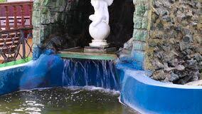 A mini fish pond can technically be created using any vessel that will hold water and typically sits above the ground, no digging required! A Small Waterfall In An Artificial Grotto In A Pond Stock Footage Video Of Fountain Fall 183532750